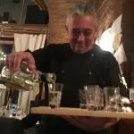 48 hours in Budapest. Image of the Host at the Chef Cafe Budapest pouring shots of the local liquor into shot glasses