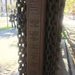 48 hours in Budapest: Image of the side of an Iron Curtain monument outside the house of terror museum. Displaying the words - Shall we live as slaves or free men? It isolated the East from the West. It split Europe and the world in two. It took away our freedom. It held us in captivity and fear. It tormented and humiliated us. And finally we tore it down