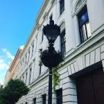 48 hours in Budapest: Image of a black lamppost surrounded with a hanging basket in front of a white building