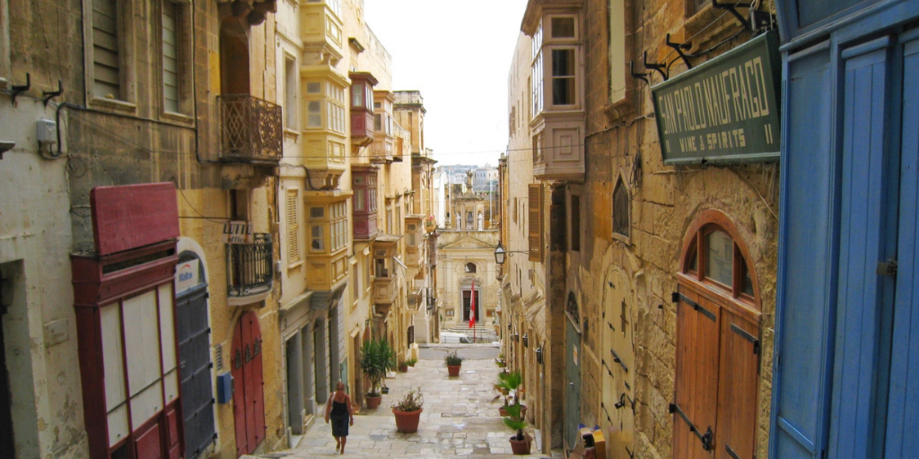 Happy Travels: Where you absolutely should go in Malta. Image of a Valletta side street