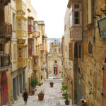Happy Travels: Where you absolutely should go in Malta. Image of a Valletta side street