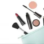 How to do your makeup in only 5 minutes. Image of peppermint makeup bag with various makeup products and brushes coming out of it