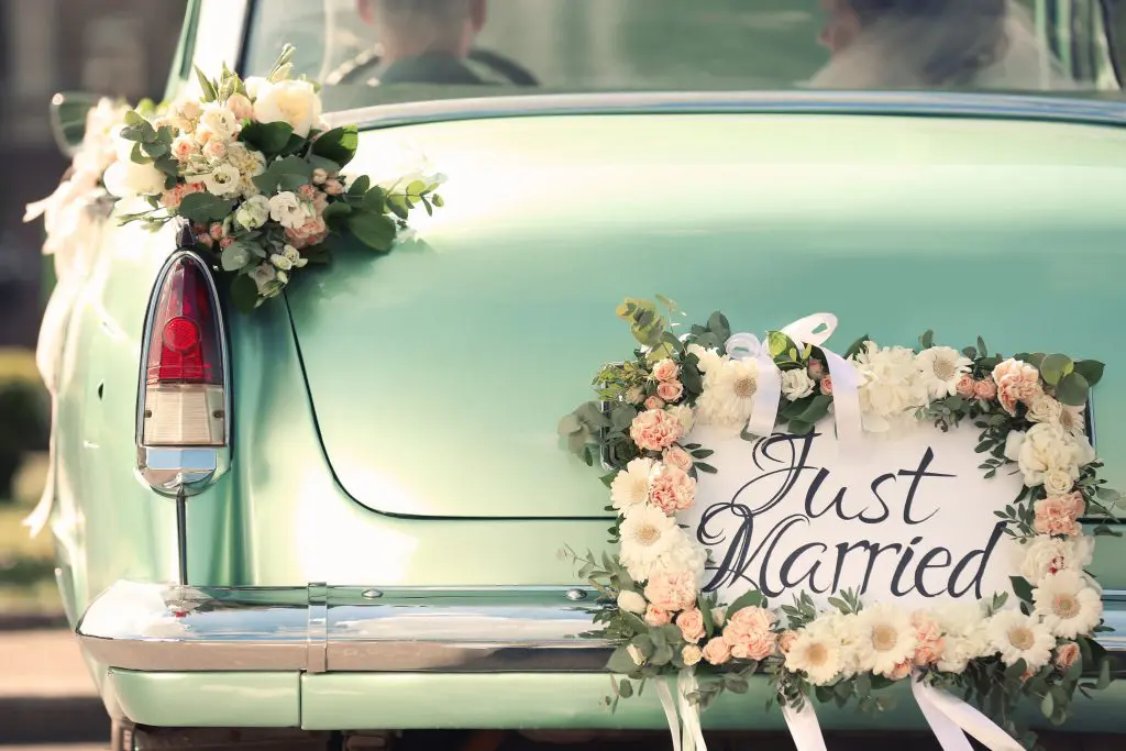 4 Tips to reduce wedding planning stress. Image of Beautiful wedding car with plate JUST MARRIED