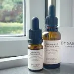 By Sarah London Organic Facial Oil Review - Image of 30ml & 10ml By Sarah London Facial oils on a windowsill