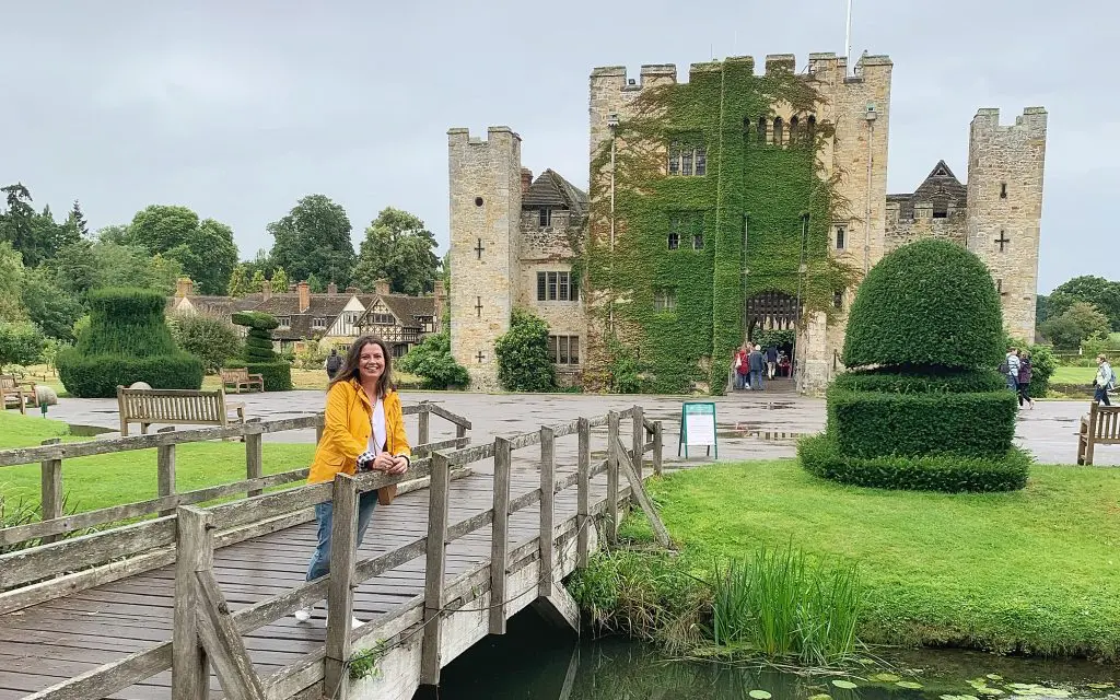 Alex Grace standing on a footbridge with Hever Castle in the background
