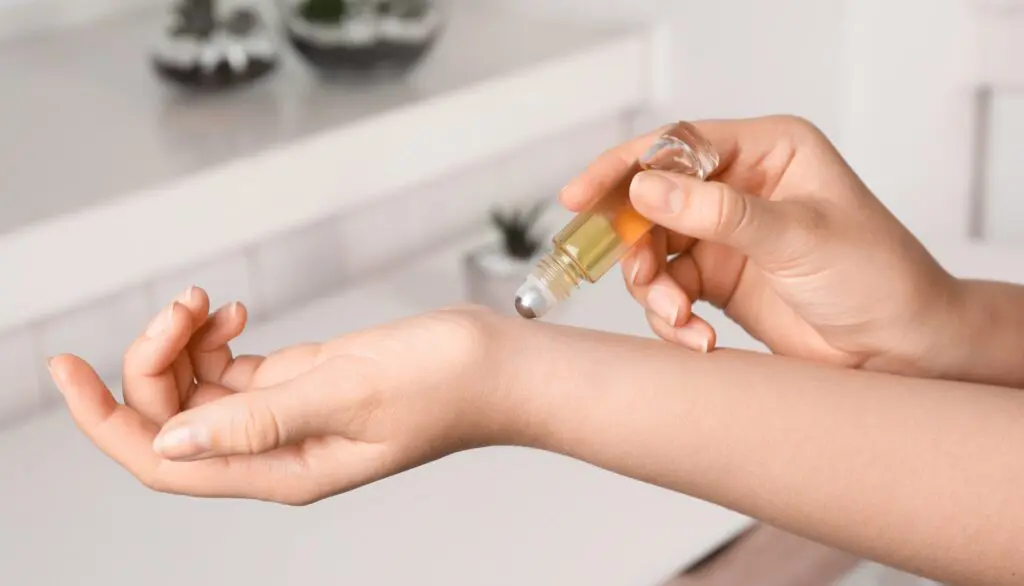 Applying essential oils with a rollerball part of our essential oils for beginners guide