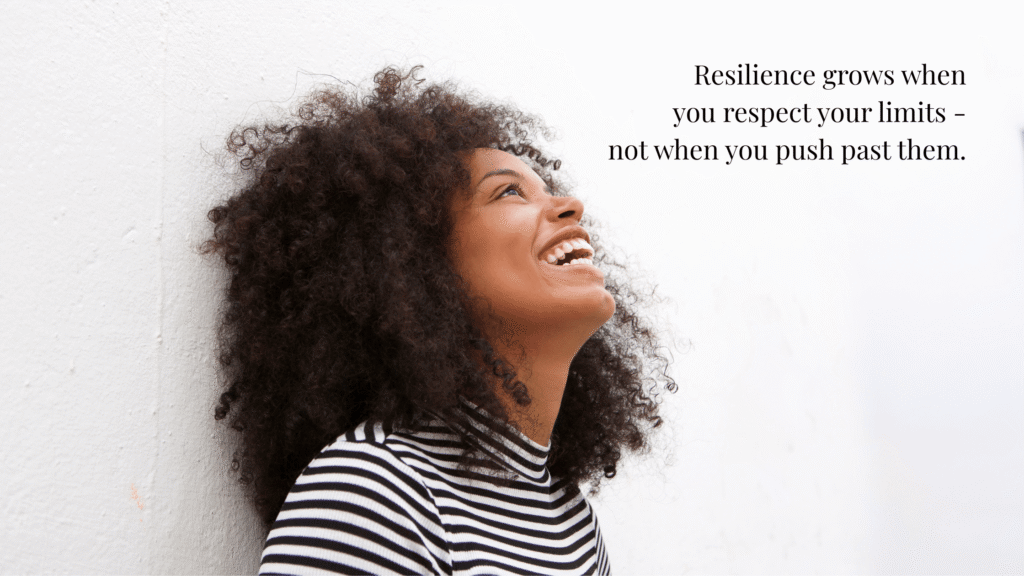 Image  of smiling woman against a white wall looking up at the words Resilience grows when you respect your limits — not when you push past them.