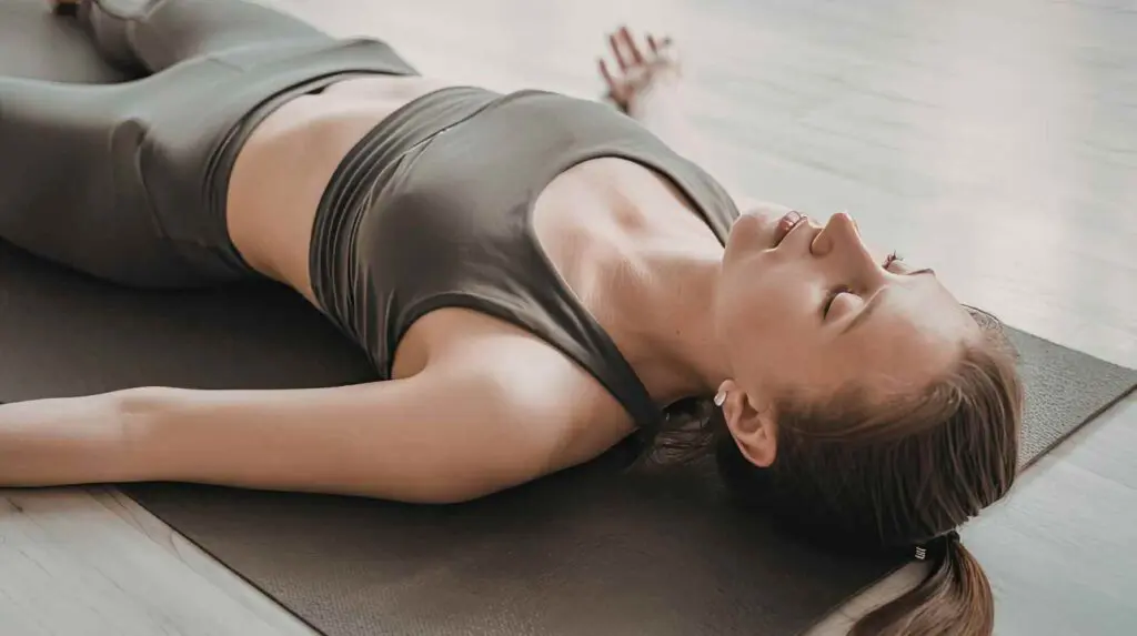 Woman resting on a yoga mat