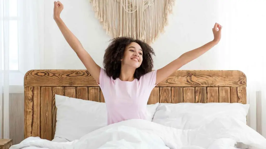 A Young Woman Waking Up Refreshed After a Good Night's Sleep