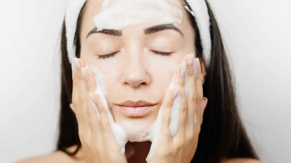 Woman cleansing her face