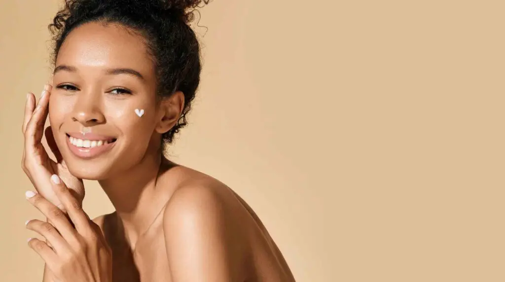 woman moisturising her skin as part of a skin detox