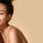 woman moisturising her skin as part of a skin detox
