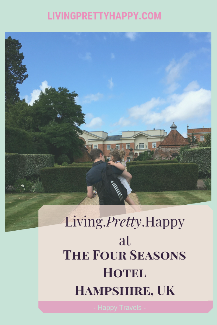 Living.Pretty.Happy at the Four Seasons Hotel Hampshire, Uk. Pinterest graphic displaying the post title on a background of a man carrying a young girl in the gardens of the Four Seasons Hotel, Hampshire. Happy travels. livingprettyhappy.com