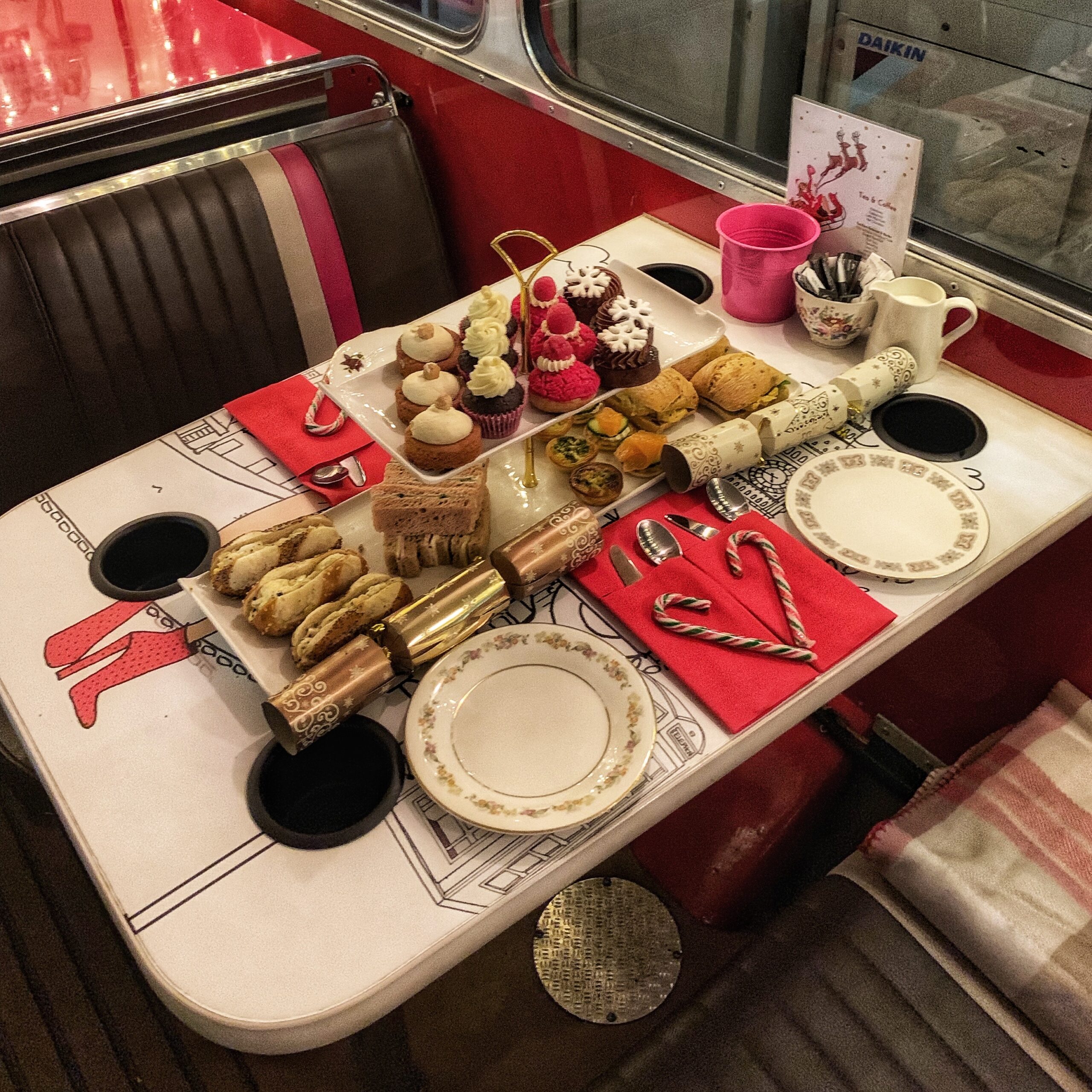 Happy days: London Afternoon Tea Bus Tour. Image of a table within the B-Bakery bus set up for a traditional afternoon tea setting