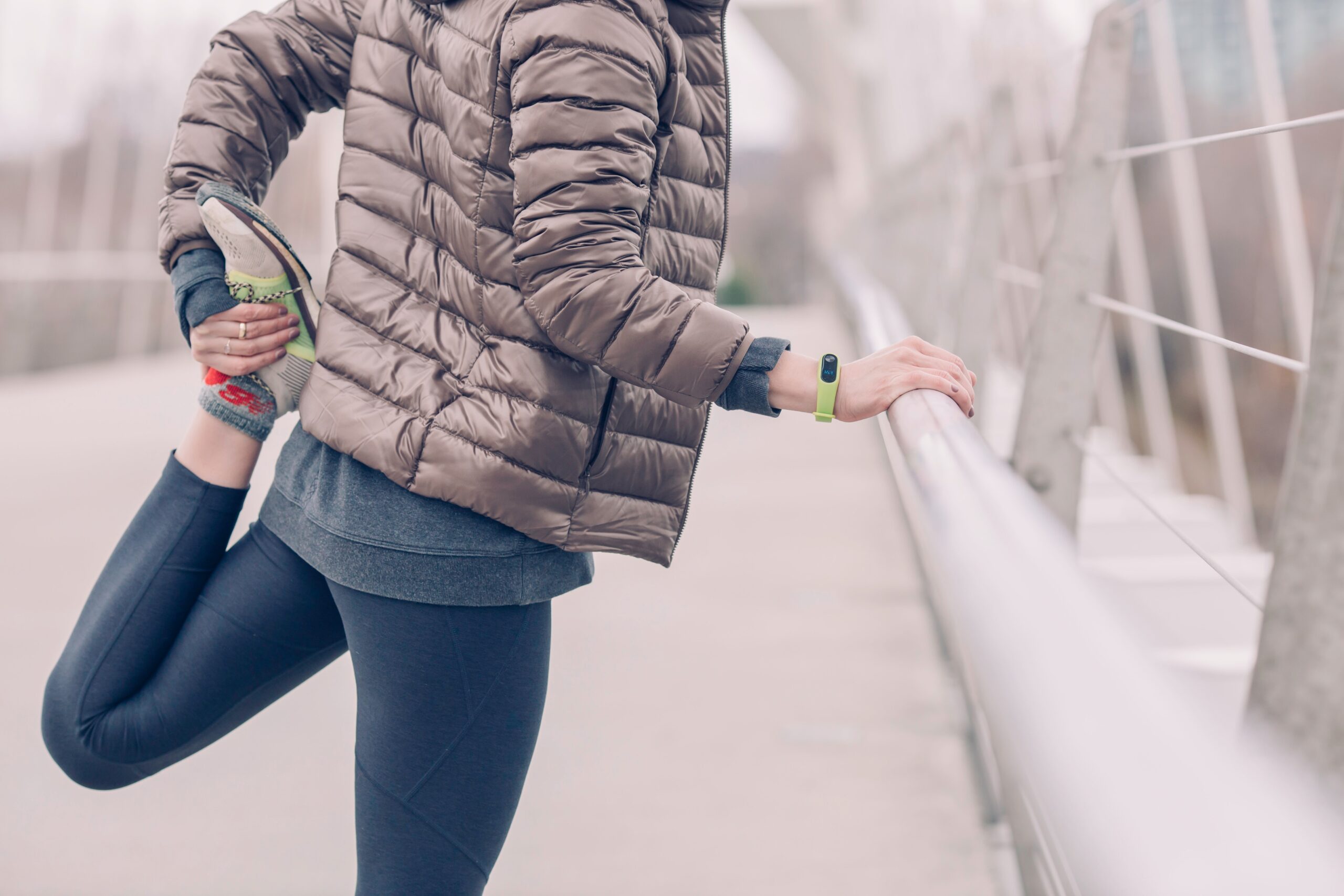 How to start running: tips for beginner runners. Image of woman stretching legs post jog