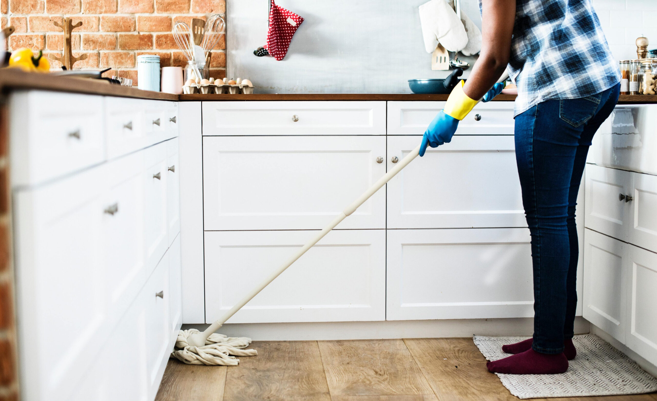 Exercise Hacks: How to be fitter without really trying. Image of adult mopping the kitchen floor