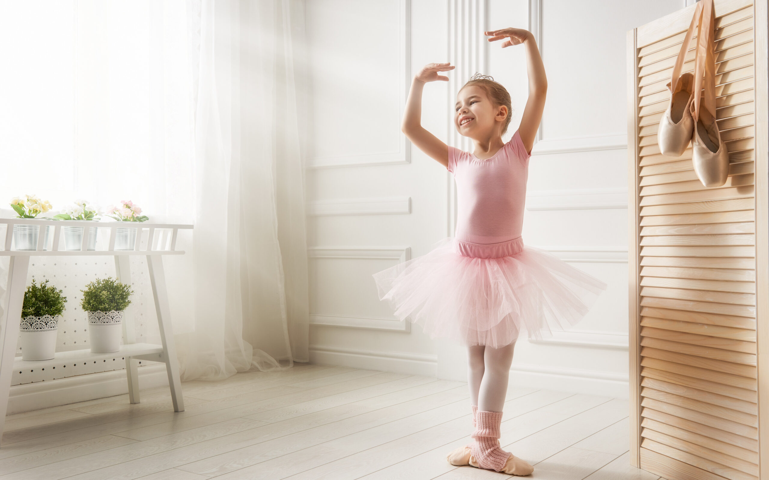 The benefits of smiling. Image of a little ballerina smiling and posing
