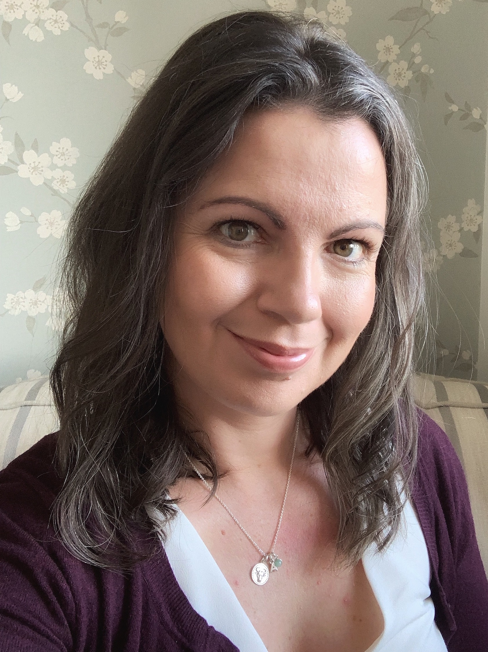 Alex Grace wearing a Hersey & Son Zodiac charm necklace