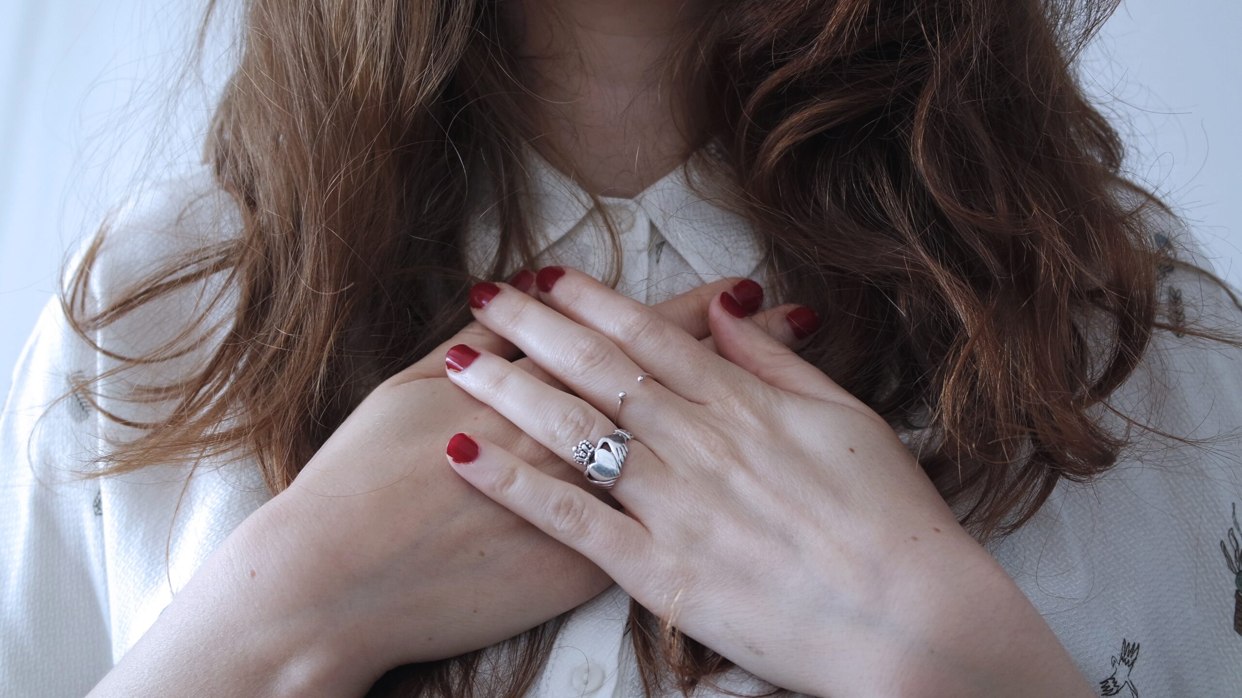 Self-awareness: a guest post by Simone Phillips. Image of woman holding her hands to her heart in a tender gesture
