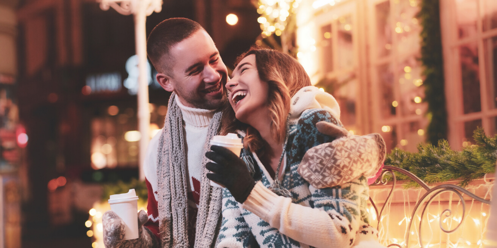 A Christmas Couple look happy & close together