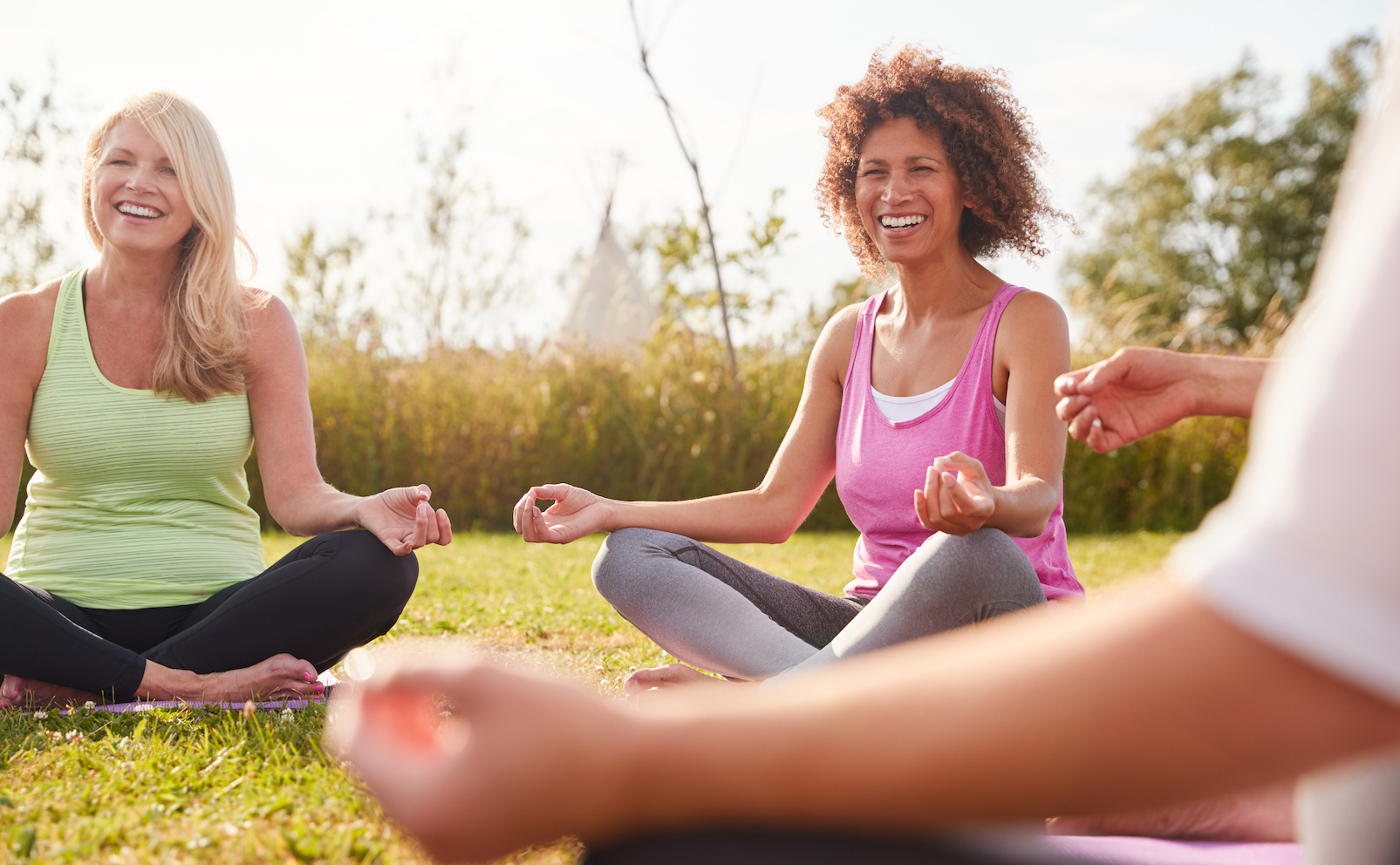 Enjoying an outdoor meditation class on a wellness retreat